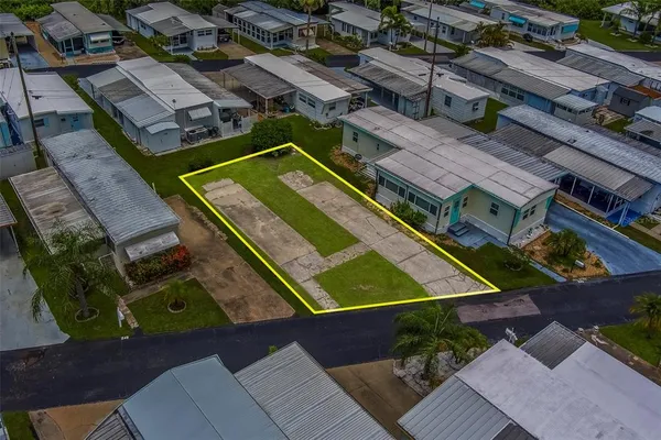 a view of a house with a big yard and potted plants