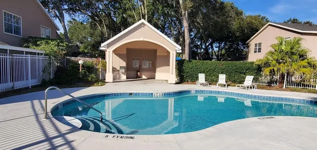 an empty room with a window and a ceiling fan