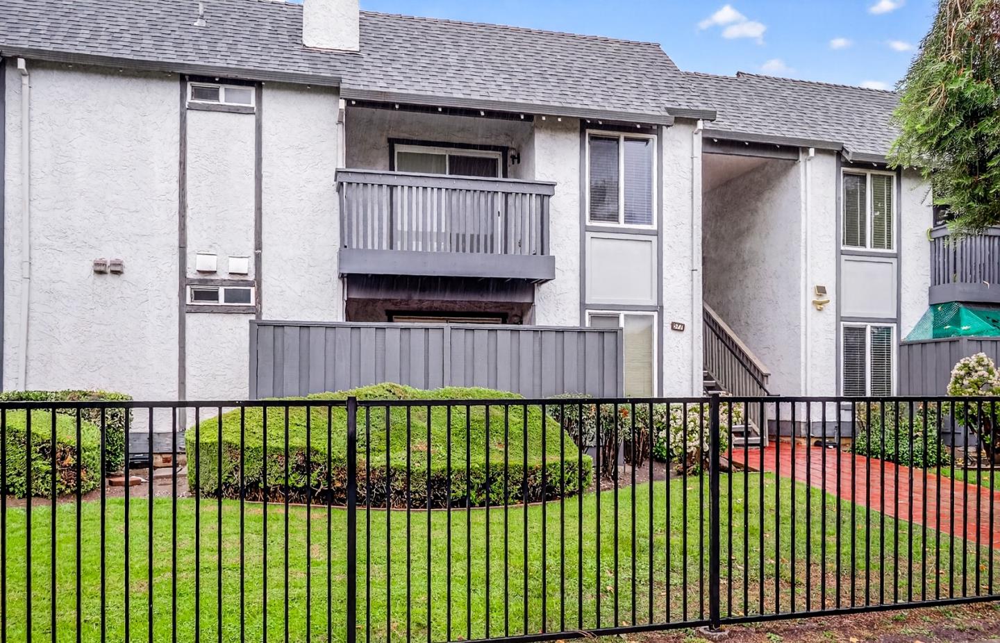 577 East Taylor Avenue, Unit F Sunnyvale, CA 94085 - Photo 2 of 7 a view of a house with a wooden fence