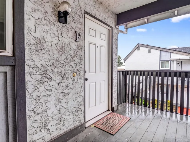 a backyard of a house with wooden fence and trees