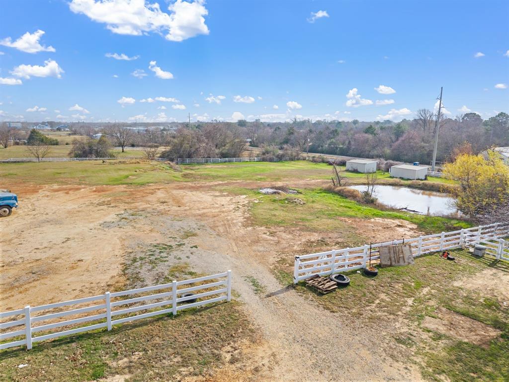 7260 Hudson Cemetery Road Mansfield, TX 76063 - Photo 38 of 40 Expansive open land featuring a white split-rail fence and a small pond