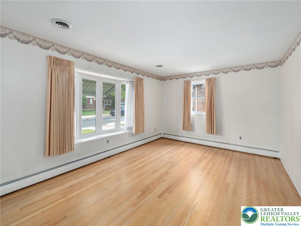 515 Franklin Street Emmaus, PA 18049 - Photo 20 of 45 a view of an empty room with wooden floor and a window