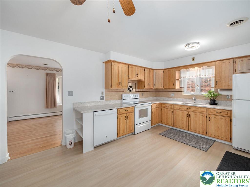 515 Franklin Street Emmaus, PA 18049 - Photo 23 of 45 a kitchen with granite countertop white cabinets and white appliances