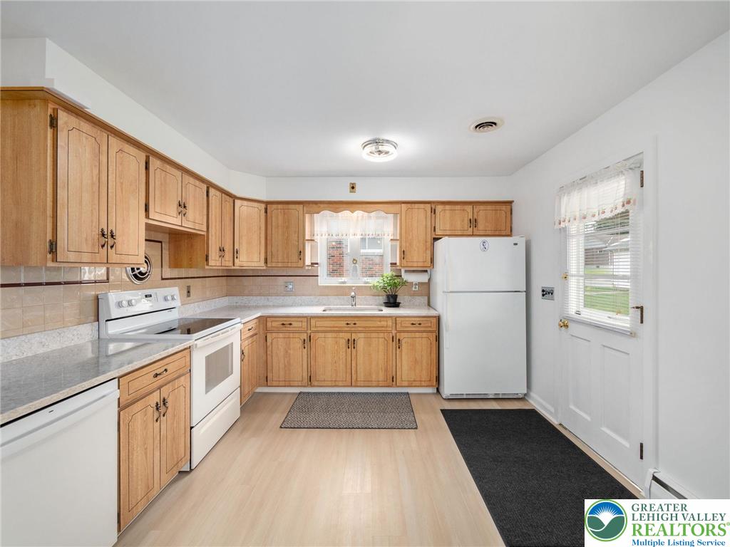 515 Franklin Street Emmaus, PA 18049 - Photo 24 of 45 a kitchen with a refrigerator a sink dishwasher with a oven and cabinets