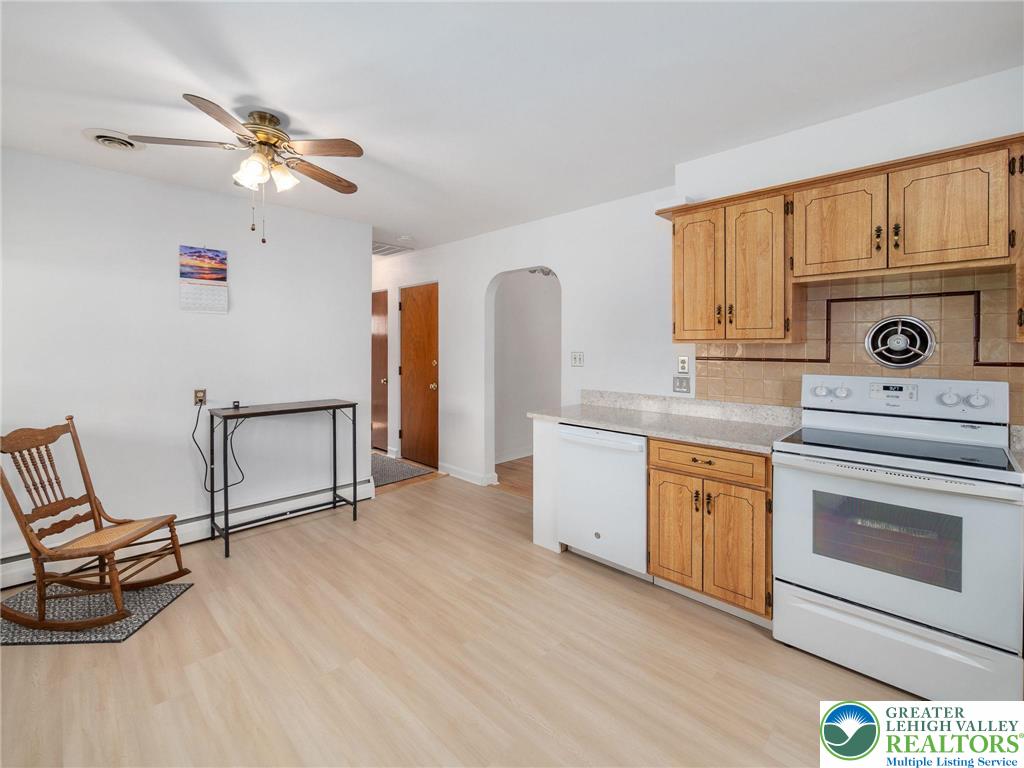 515 Franklin Street Emmaus, PA 18049 - Photo 25 of 45 a kitchen with granite countertop a stove a sink and a microwave