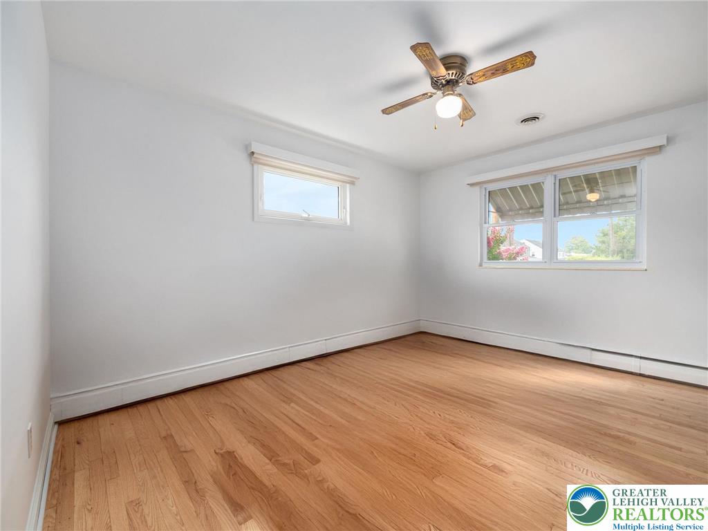 515 Franklin Street Emmaus, PA 18049 - Photo 33 of 45 an empty room with wooden floor chandelier fan and windows