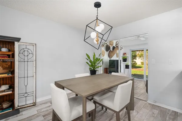 a view of a dining room with furniture and a chandelier