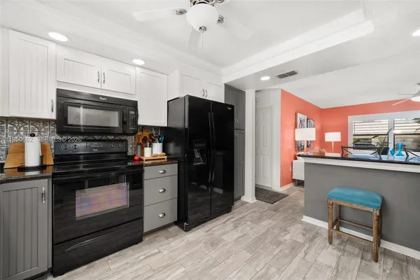 a kitchen with stainless steel appliances a stove refrigerator sink and microwave