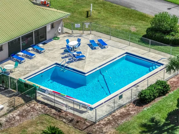 a view of a balcony with furniture and outdoor kitchen
