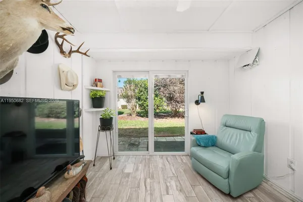 a living room with furniture and a floor to ceiling window
