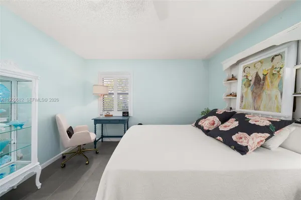 a bedroom with furniture and a window