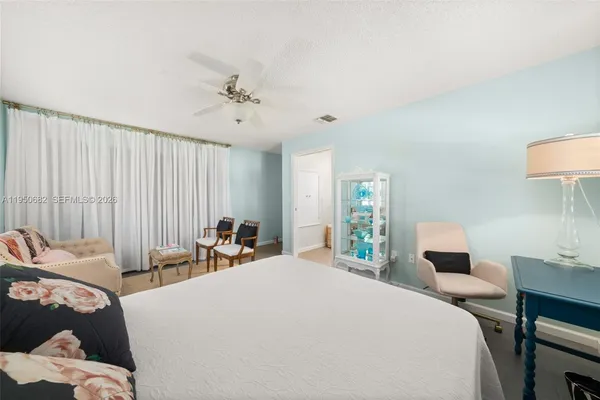 a bedroom with a bed and a lamp