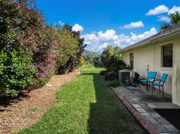 a view of a backyard with sitting area