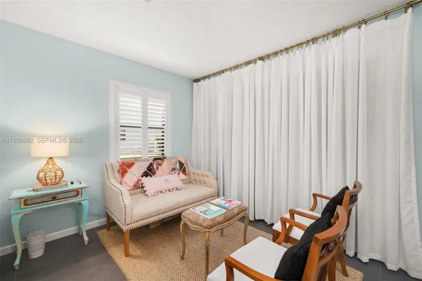 a bedroom with furniture and a window