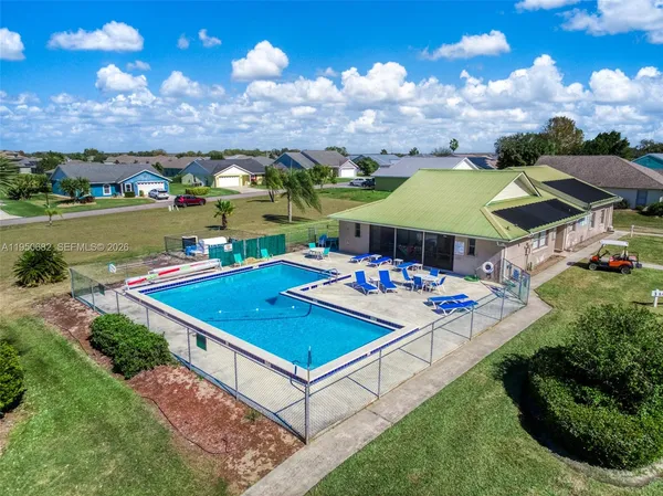 a view of a swimming pool with an outdoor seating and a garden