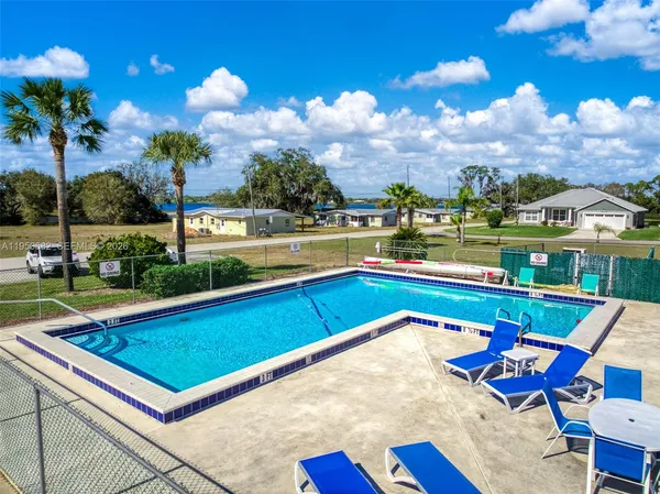 a view of swimming pool with outdoor seating