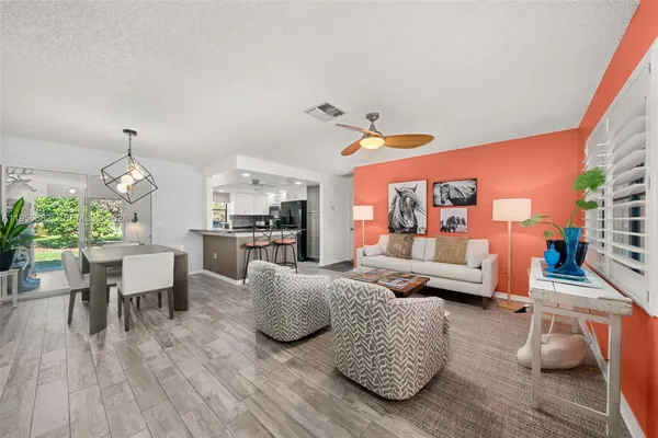 a living room with furniture and wooden floor