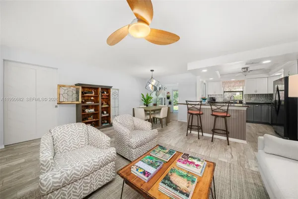 a living room with furniture and kitchen view
