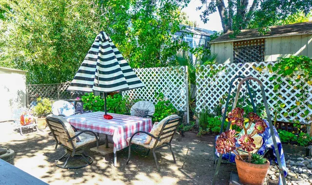 a kitchen with stainless steel appliances a sink a stove and white cabinets
