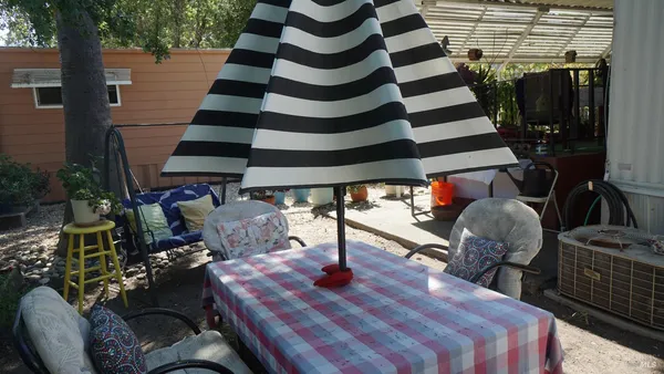 a wooden bench sitting in the middle of a yard
