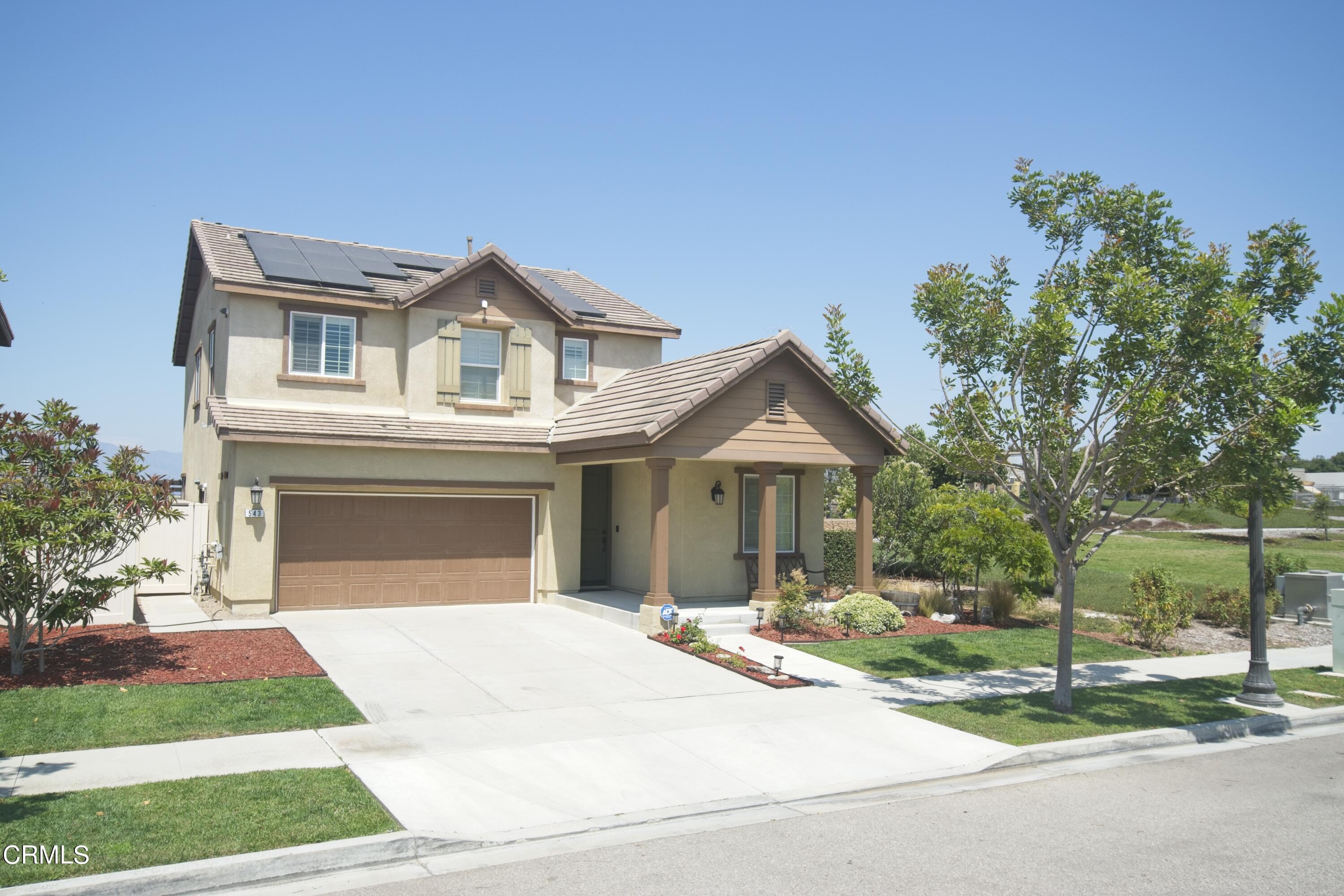 543 Xanadu Way Oxnard, CA 93036 - Photo 2 of 19 a front view of a house with a yard and garage