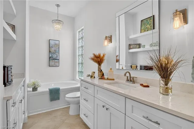 a bathroom with double vanity sink a toilet and a mirror