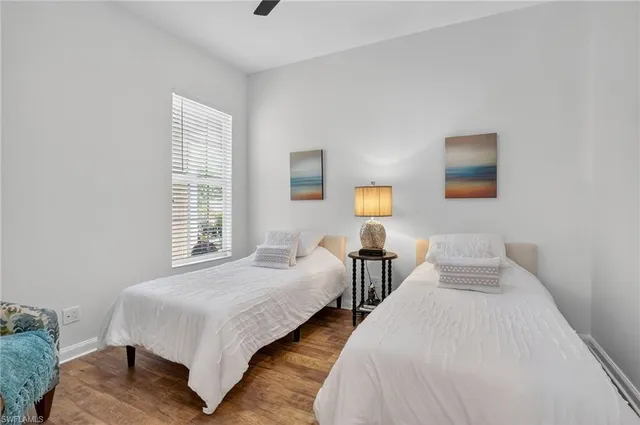 a bedroom with two beds and a window