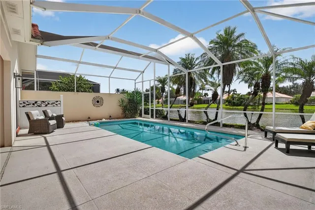 a view of a patio with a table and chairs under an umbrella