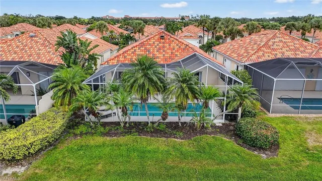 an aerial view of residential house with outdoor space and trees around