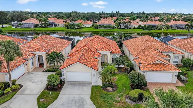 an aerial view of a house with a garden and lake view