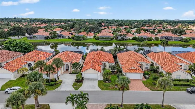 an aerial view of residential houses with outdoor space and street view