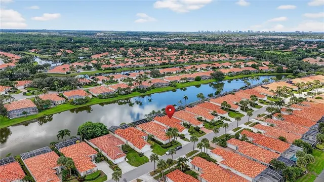 an aerial view of residential houses with outdoor space and river