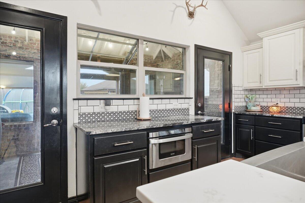 3013 111th Street Lubbock, TX 79423 - Photo 13 of 37 a kitchen with a stove and a refrigerator