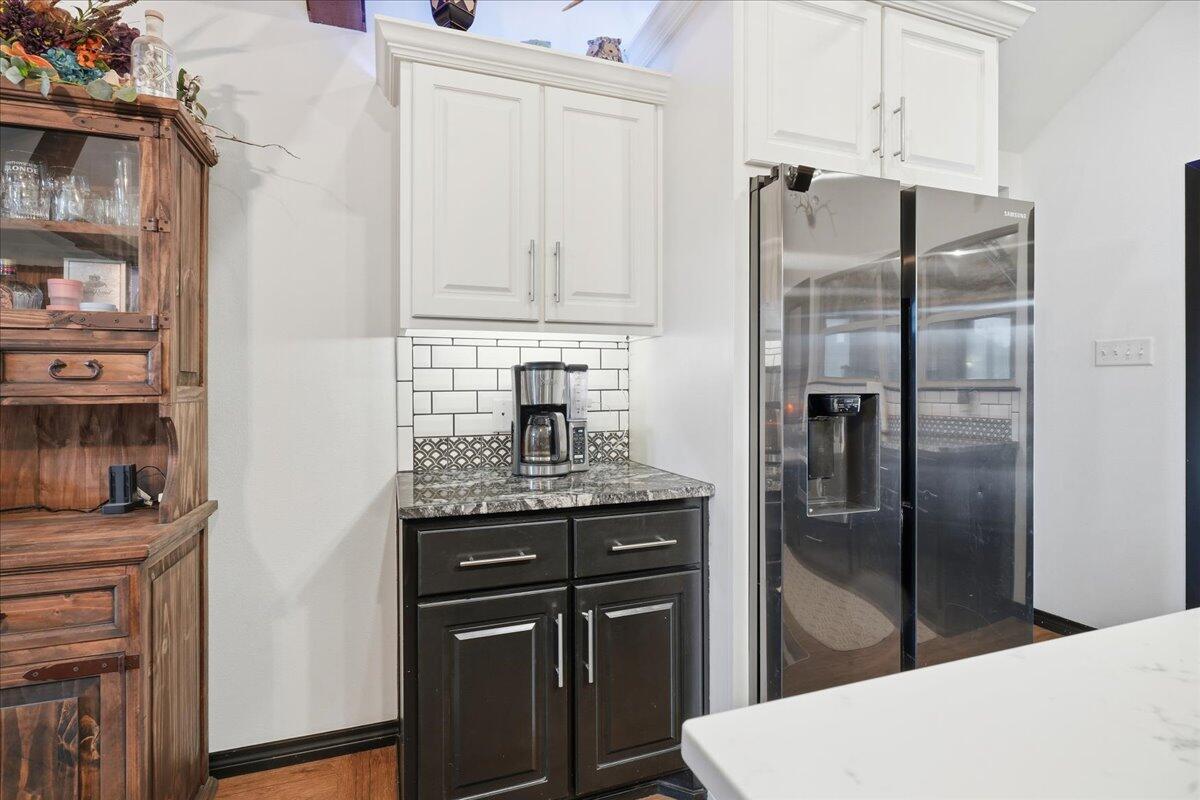 3013 111th Street Lubbock, TX 79423 - Photo 14 of 37 a kitchen with stainless steel appliances granite countertop a refrigerator a stove and a sink with cabinets