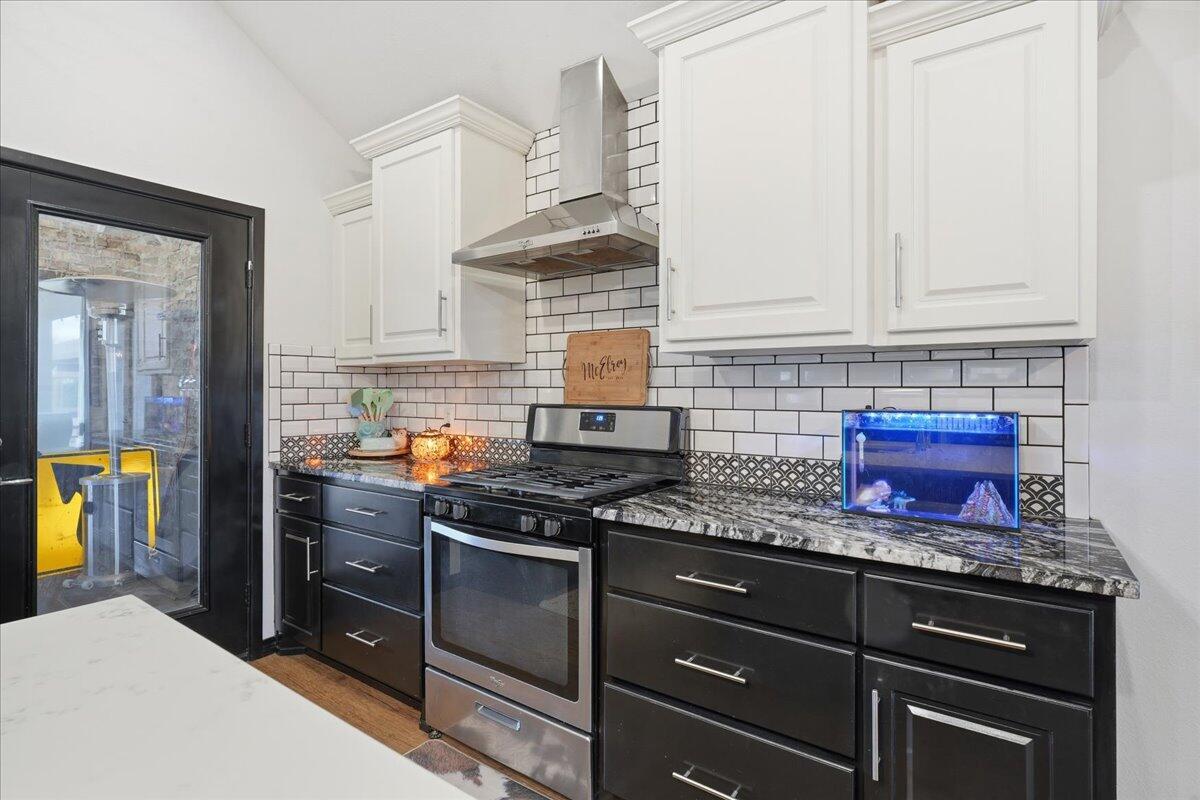 3013 111th Street Lubbock, TX 79423 - Photo 15 of 37 a kitchen with granite countertop a stove and a sink
