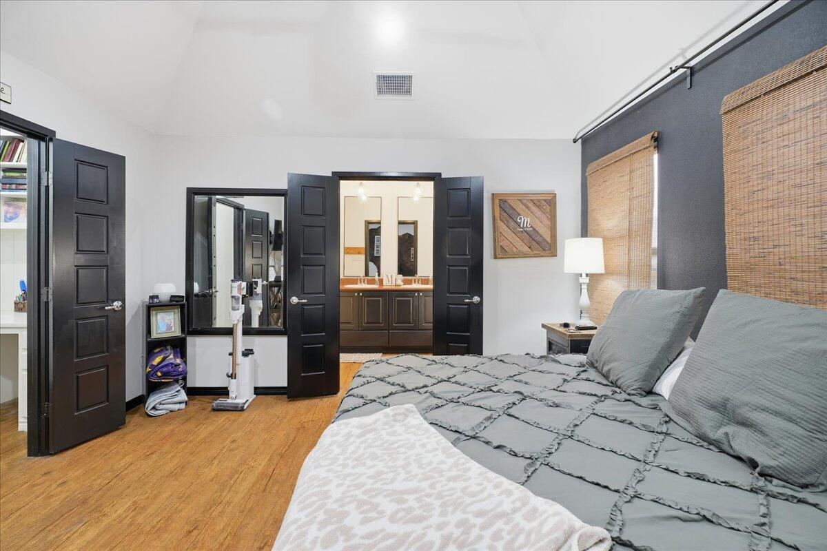 3013 111th Street Lubbock, TX 79423 - Photo 18 of 37 a bedroom with double bed and a large mirror