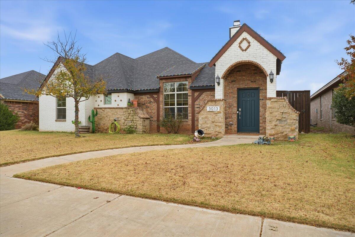 3013 111th Street Lubbock, TX 79423 - Photo 2 of 37 a front view of a house with a yard