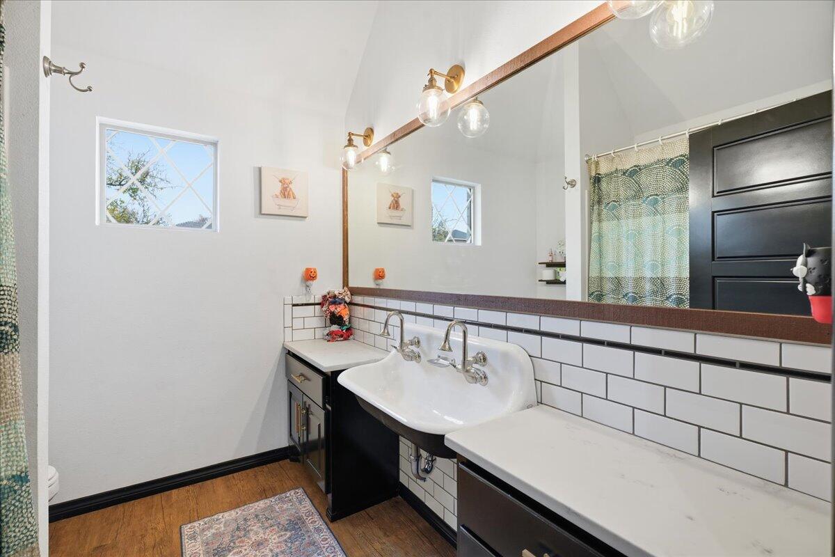 3013 111th Street Lubbock, TX 79423 - Photo 28 of 37 a bathroom with a sink and a mirror