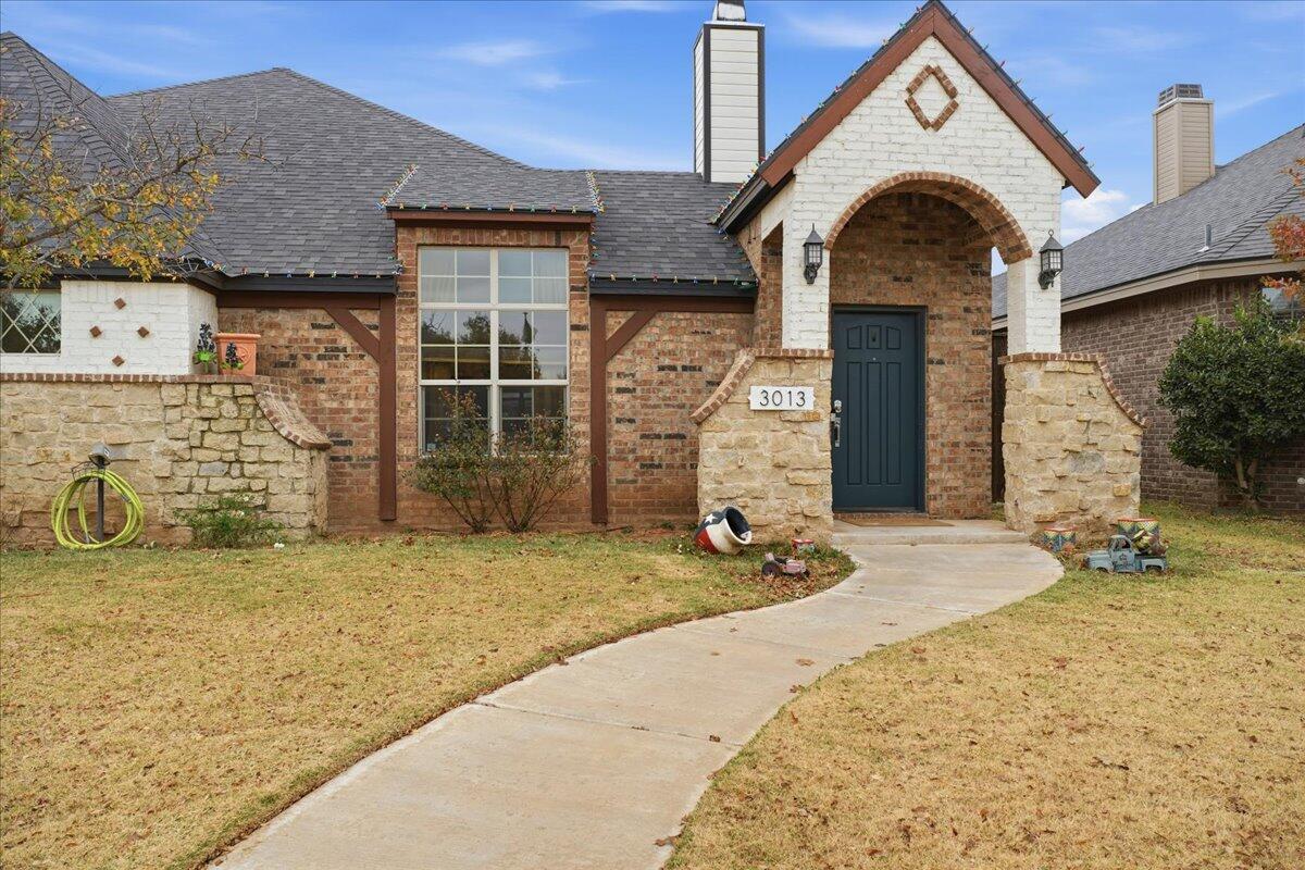3013 111th Street Lubbock, TX 79423 - Photo 3 of 37 a front view of a house with a yard
