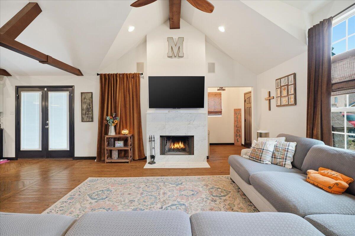 3013 111th Street Lubbock, TX 79423 - Photo 7 of 37 a living room with furniture a flat screen tv and a fireplace