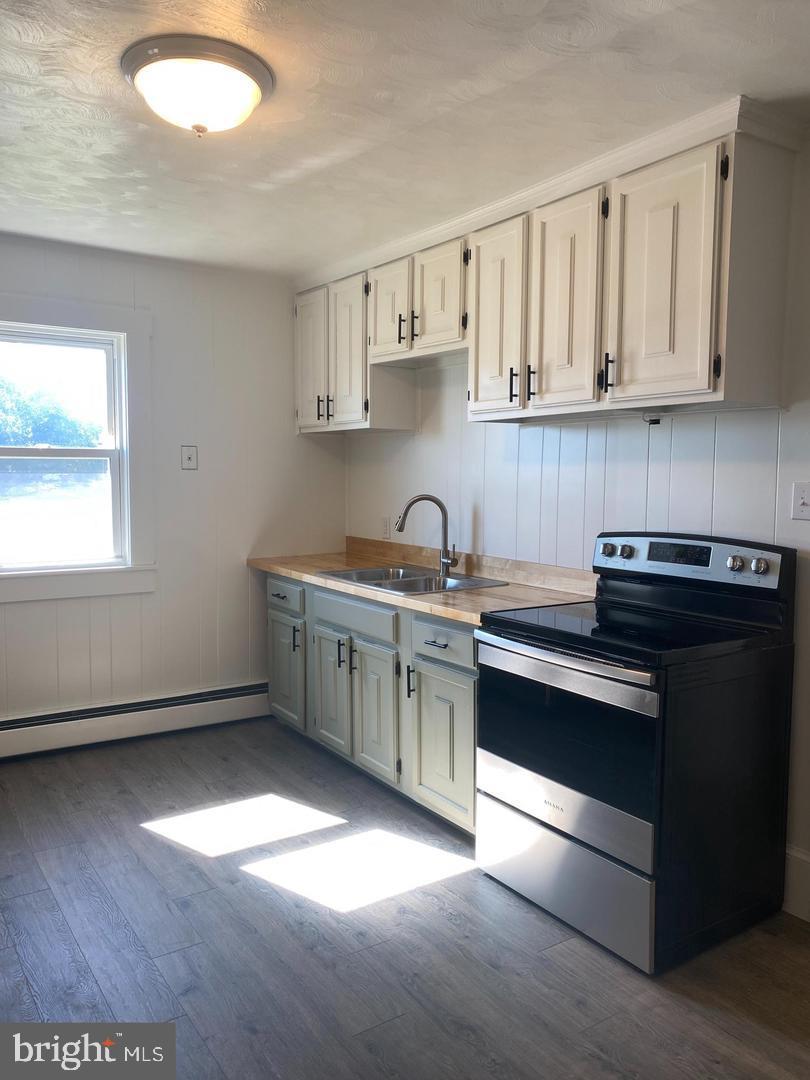24861 Three Notch Road Hollywood, MD 20636 - Photo 2 of 8 a kitchen with stainless steel appliances granite countertop a sink dishwasher a stove and a refrigerator with wooden floor