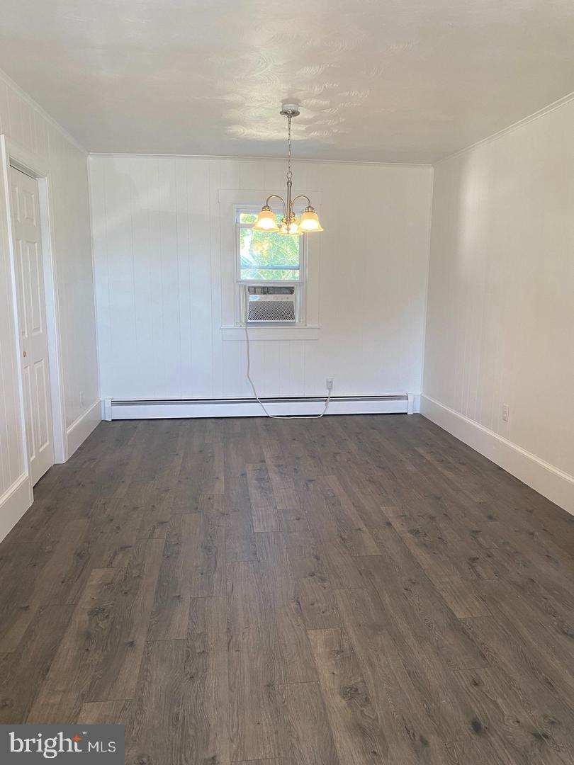 24861 Three Notch Road Hollywood, MD 20636 - Photo 4 of 8 a view of a room with wooden floor and chandelier