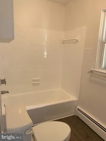 a bathroom with a toilet and a bathtub