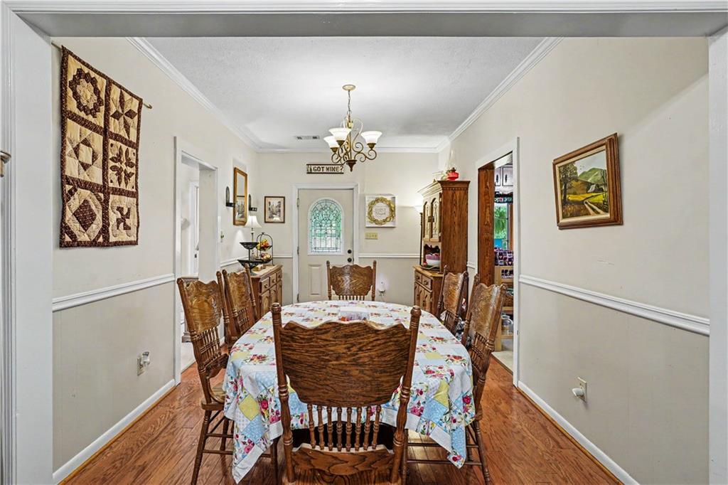 355 Inman Road Hampton, GA 30228 - Photo 14 of 47 a view of a dining room with furniture and a chandelier