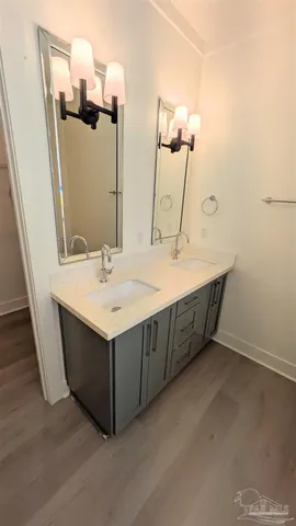 a bathroom with a sink vanity and a mirror