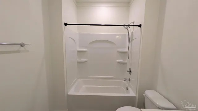 a bathroom with a shower and toilet