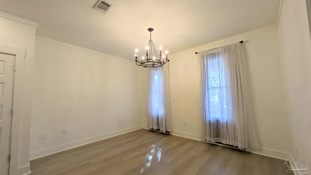 a view of a chandelier in big room and chandelier fan