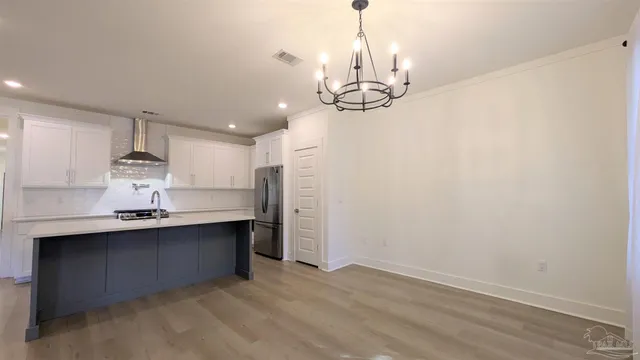 a view of a kitchen with a sink stainless steel appliances and cabinets