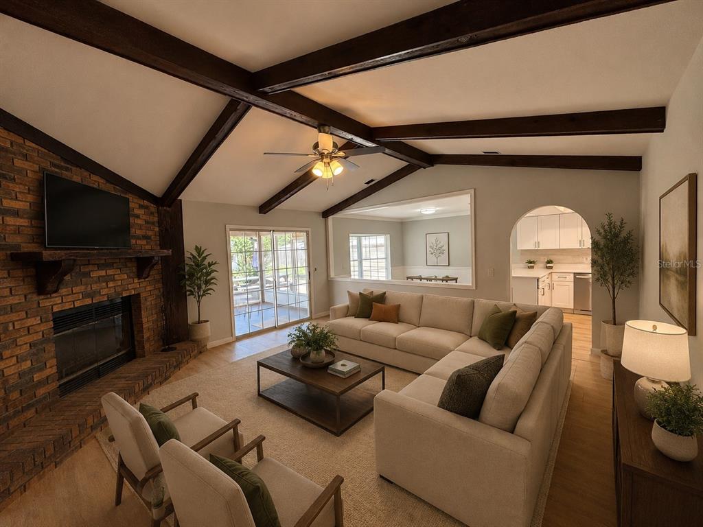 9801 Southeast Sunset Harbor Road Summerfield, FL 34491 - Photo 6 of 37 a living room with furniture and a flat screen tv