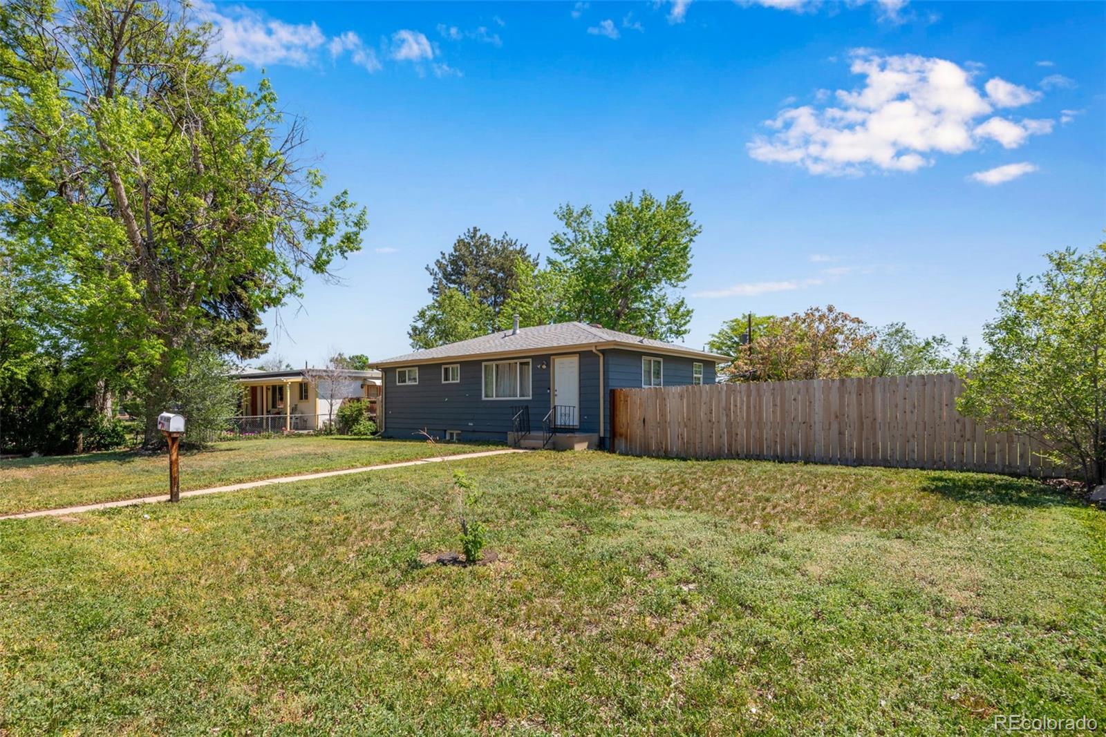 934 Linley Court Denver, CO 80204 - Photo 1 of 17 a front view of a house with a yard